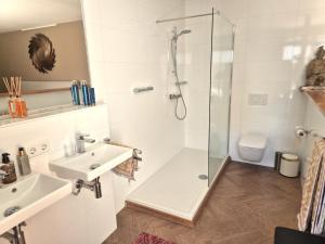 a bathroom with a shower and a sink at Villa Oasis in Lelystad +27 photos