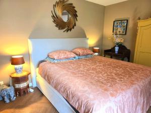 a bedroom with a bed and a mirror on the wall at Villa Oasis in Lelystad
