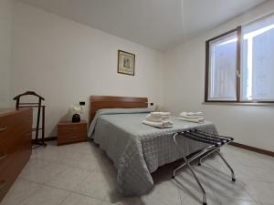 a bedroom with a bed with a chair and a window at Villa Romea in Guidizzolo