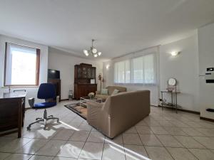 a living room with a couch and a chair at Villa Romea in Guidizzolo