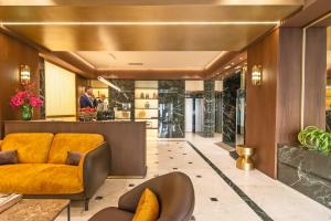 a lobby with an orange chair and a bar at Hotel Accademia in Rome