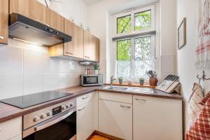 a kitchen with a sink and a microwave at Ferienhof Schönberg in Lindow