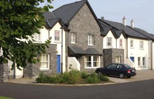 a house with a car parked in front of it at Bunratty Holiday Homes in Bunratty