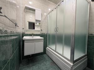 a bathroom with a shower and a sink at Mayden Tower apartment in Baku +85 photos