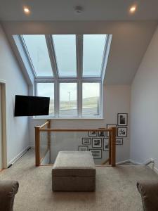 a living room with a skylight and a tv at Kelsingra Self Catering in Lerwick/Tingwall Airport