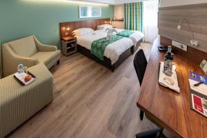 a hotel room with a bed and a desk at City Lodge Hotel Durban in Durban +21 photos