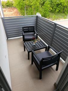 a balcony with two benches and a table on it at Ana in Posušje