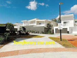a building with a parking sign in front of it at 22 Pimpama Home in Pimpama