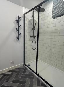 a shower with a glass door in a bathroom at Kelsingra Self Catering in Lerwick/Tingwall Airport