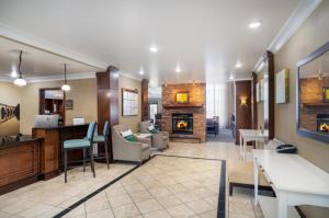 a lobby with a living room with a fireplace at Staybridge Suites Augusta by IHG in Augusta
