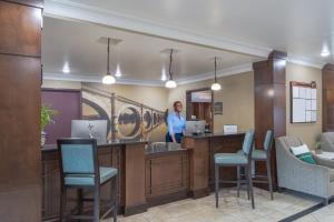 a man standing at a reception desk in a waiting room at Staybridge Suites Augusta by IHG in Augusta
