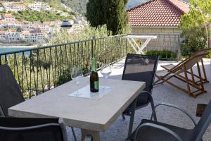 a table with two glasses and a bottle of wine at Sea View apartment 50 m from St Rok Beach in Pučišća