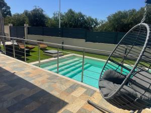 a swing sitting next to a swimming pool at Villa Lenuska in Quartu SantʼElena