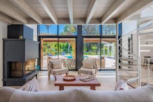 a living room filled with furniture and a fireplace at Villa avec piscine chauffée, proche Saint-Tropez et plages in Gassin