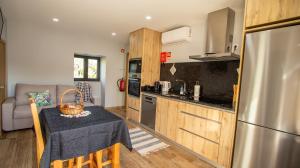 a kitchen with a table with a basket on it at A Casa do Penedo - Arcos de Valdevez in Arcos de Valdevez +14 photos