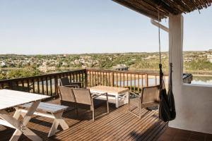 a balcony with a table and chairs and a view at Idylla Guest Home in Kenton on Sea