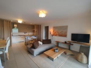 a living room with a couch and a table at Home 33 in Saint-Rémy-lès-Chevreuse