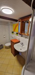 a bathroom with a white sink and a toilet at Fewo2-Fliegenpilz in Bad Suderode +15 photos