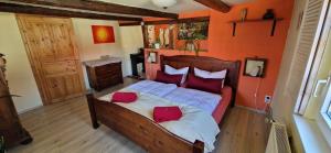 a bedroom with a bed with red pillows on it at Fewo2-Fliegenpilz in Bad Suderode
