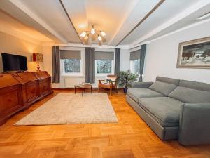a living room with a couch and a tv at Drei Linden Rosenwall in Wolfenbüttel