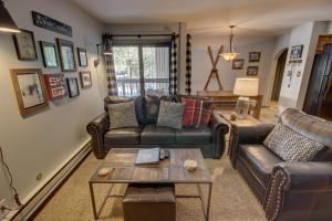 a living room with leather couches and a coffee table at Wild Irishman 1059 by SummitCove Lodging in Colorado in Keystone +34 photos