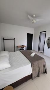 a bedroom with a large white bed with a ceiling at Golden Silver UNIQUE in Curvelo +14 photos