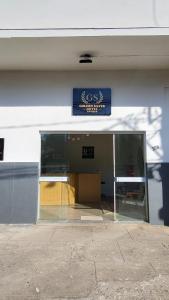 a store front with a glass door and a sign at Golden Silver UNIQUE in Curvelo