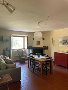 a living room with a table and a couch at Casa Lago di Brulli in Casole dʼElsa