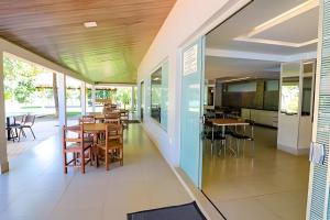 a dining area with tables and chairs in a building at Pontal do Lago Flat Residence, aproveite dias incríveis em família às margens do lago Corumbá in Caldas Novas