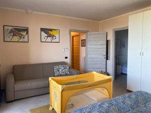 a living room with a couch and a table at Flowers & garden apartment con vista lago in Manerba del Garda +51 photos