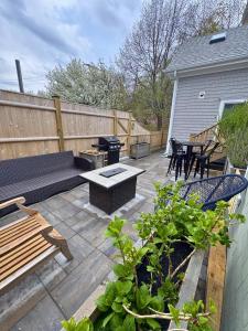 a patio with benches and tables and a grill at Ocean light | Deck + Patio • Central P-Town in Provincetown +5 photos