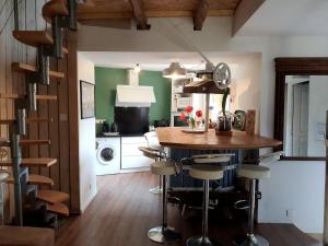 a kitchen with a kitchen island with bar stools at La cazelle, dependance du 18 siecle, jacuzzi in Carsac-Aillac