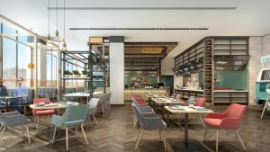 a rendering of a restaurant with tables and chairs at Holiday Inn Beihai Silver Beach in Beihai