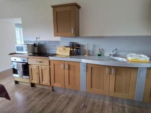 a kitchen with a sink and a counter top at Elderflower Cottage in Stamford