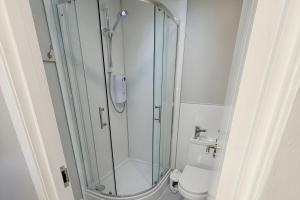 a glass shower in a bathroom with a toilet at Hopetoun Bothy in Leadhills