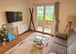 a living room with a couch and a large window at Chalet Julian in Žaga