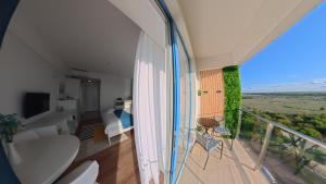a bathroom with a balcony with a tub and a toilet at Cozy Studio Olimp in Olimp