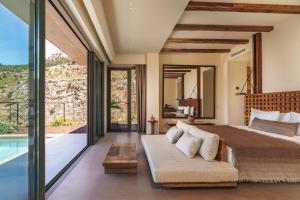 a bedroom with a large bed and a pool at Klay Hotel Faralya Adults Only in Faralya