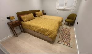 a bedroom with a bed and a table and a chair at El Olivo in Níjar