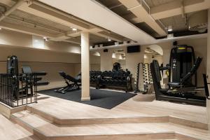 a gym with several treadmills and elliptical machines at Thon Hotel Vasa in Stockholm