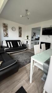 a living room with a couch and a table at B by the sea in Scratby