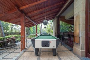 a pool table on a porch with awning at Bull Costa Canaria & Spa - Only Adults in San Agustin
