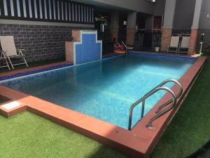 a large swimming pool in a building at ADJ Royalty Hotel & Suites in Benin City