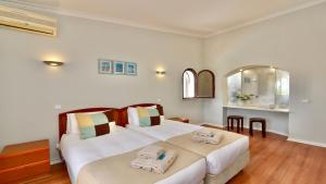 a bedroom with two beds with towels on them at Villa Oasis by Cleverdetails private pool, walk distance in Vilamoura +41 photos