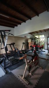 a gym with two tread machines in a room at Posada del Angel in Colonia del Sacramento