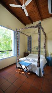 a bedroom with a canopy bed and a window at Posada del Angel in Colonia del Sacramento +44 photos