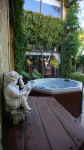 a statue of a little girl sitting next to a tub at Posada del Angel in Colonia del Sacramento