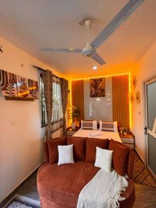 a living room with a couch and a bed at Homes by Najma in Mtwapa