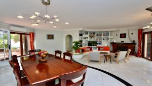 a dining room and living room with a table and chairs at Villa Oasis by Cleverdetails private pool, walk distance in Vilamoura