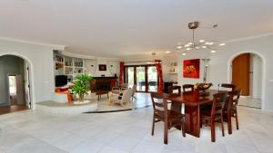 a dining room and living room with a table and chairs at Villa Oasis by Cleverdetails private pool, walk distance in Vilamoura